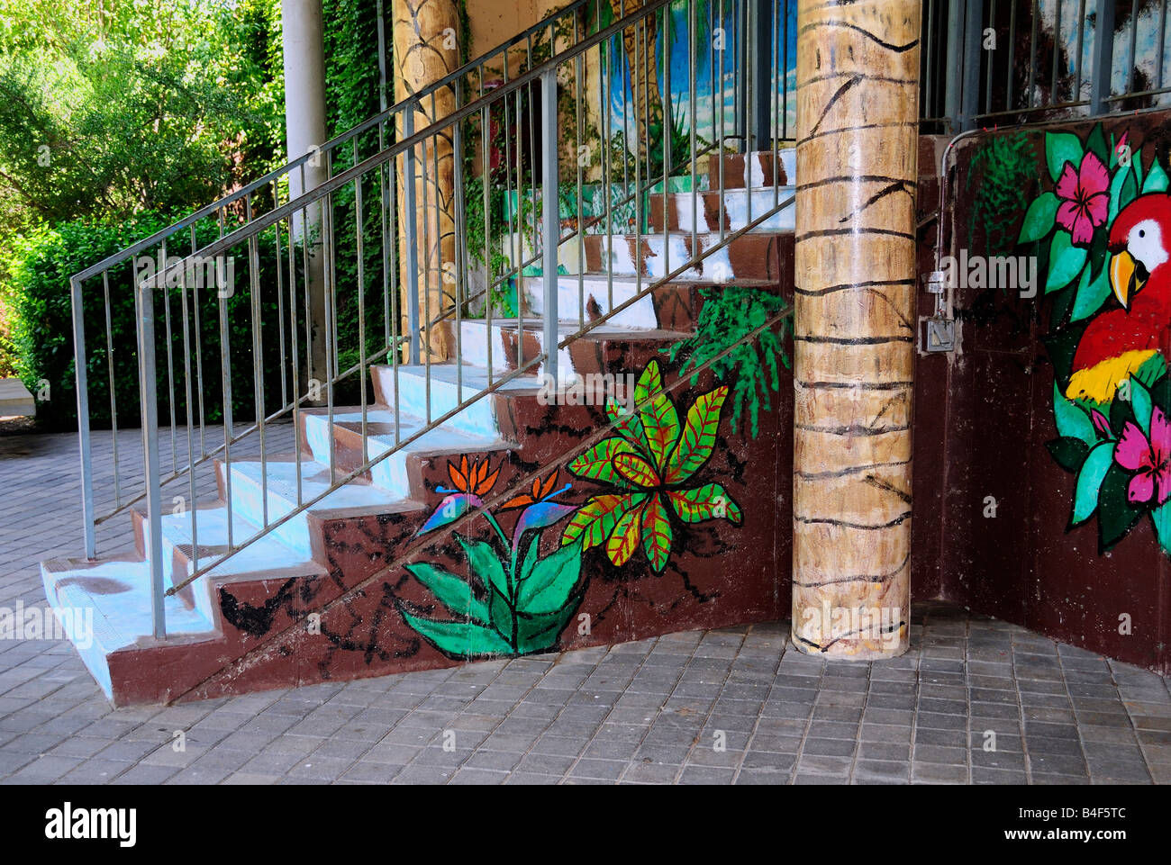 Colorful wall paintings decorate the front and stairway of a Mexican