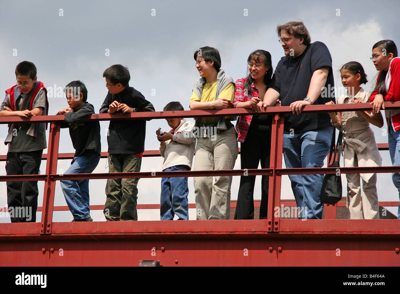 diversity family on a red bridge Stock Photo - Alamy