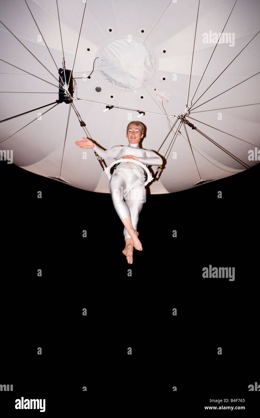 A 'Helionaut' suspended from a 'Heliosphere' waves to an amazed crowd. Stock Photo