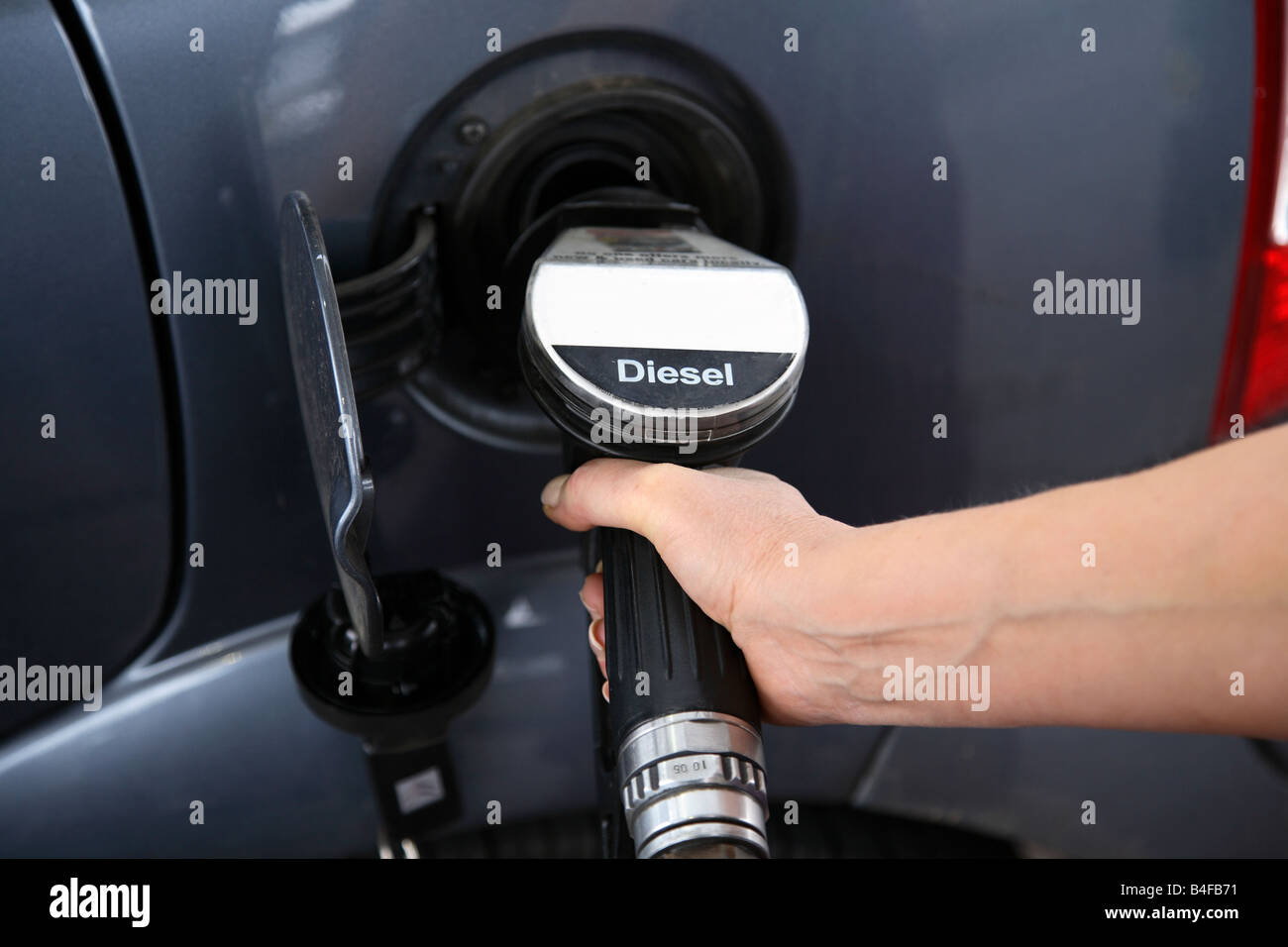 Woman filling car with fuel. Stock Photo