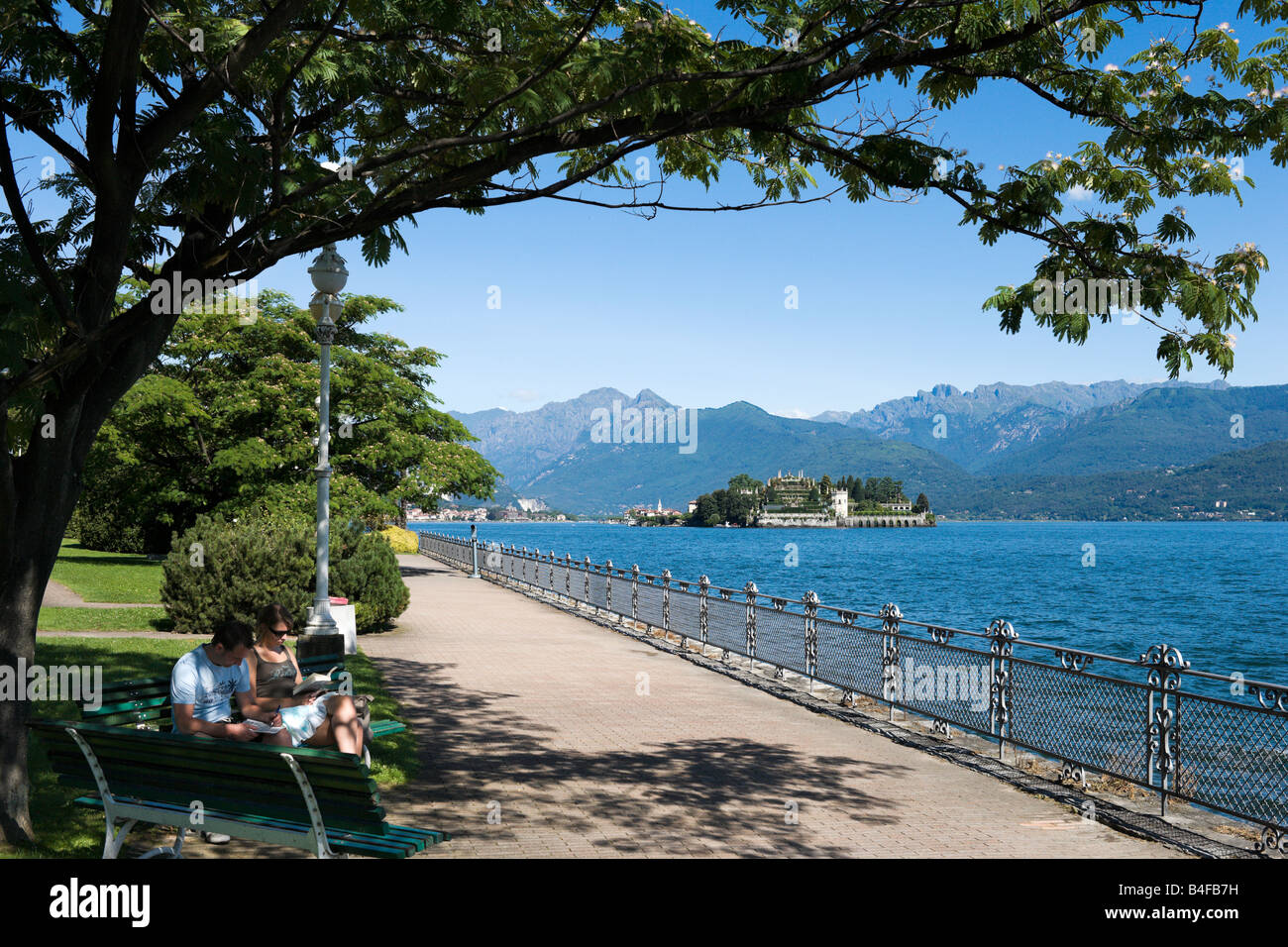 Promenade on the lakefront at Stresa looking towards Isola Bella (one of the Isole Borromee), Lake Maggiore, Italy Stock Photo