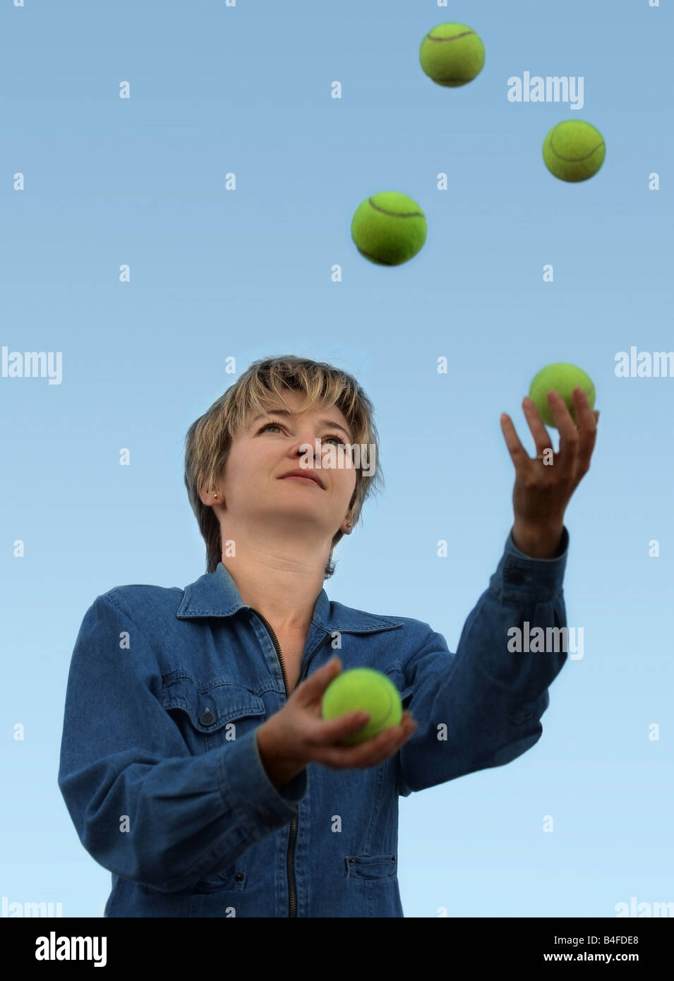 Young woman juggling with tennis balls Stock Photo Alamy