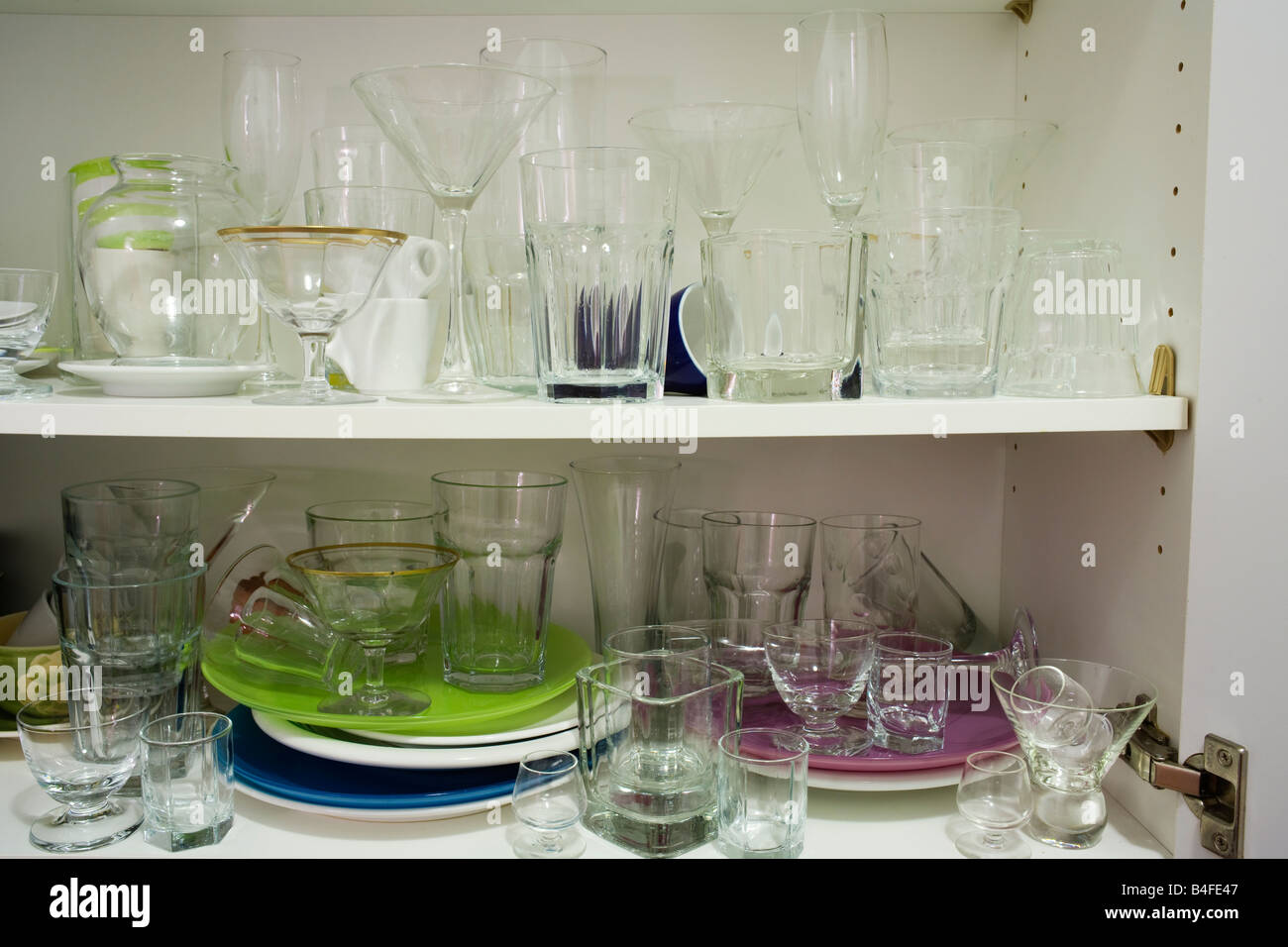 Messy glass kitchen cupboard Stock Photo - Alamy