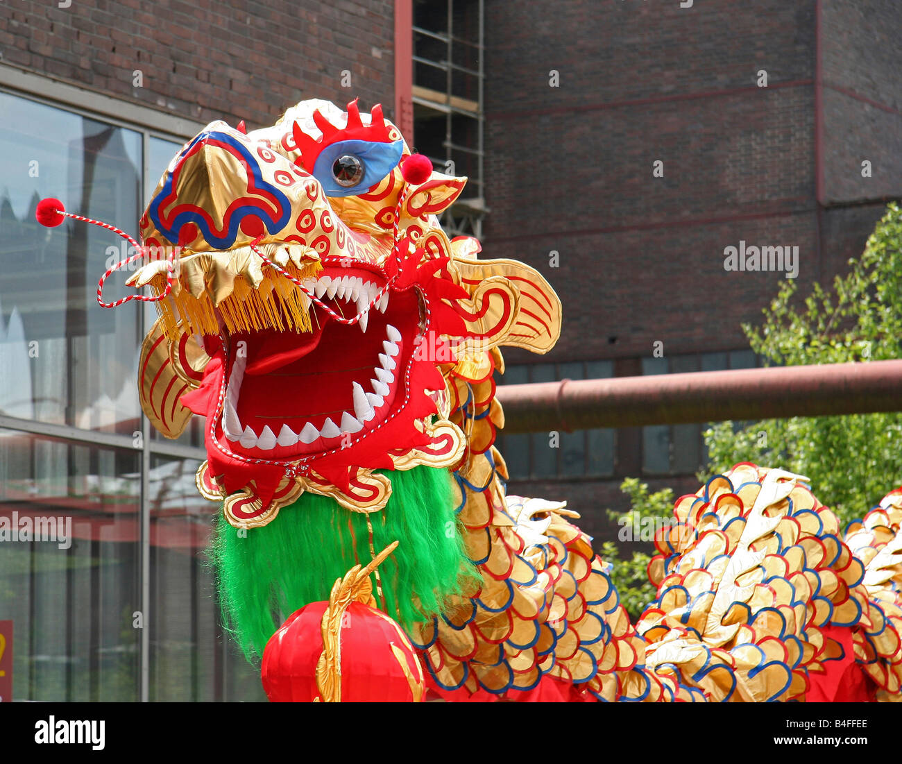 dragon dance - dragon in front of an old brick building Stock Photo - Alamy