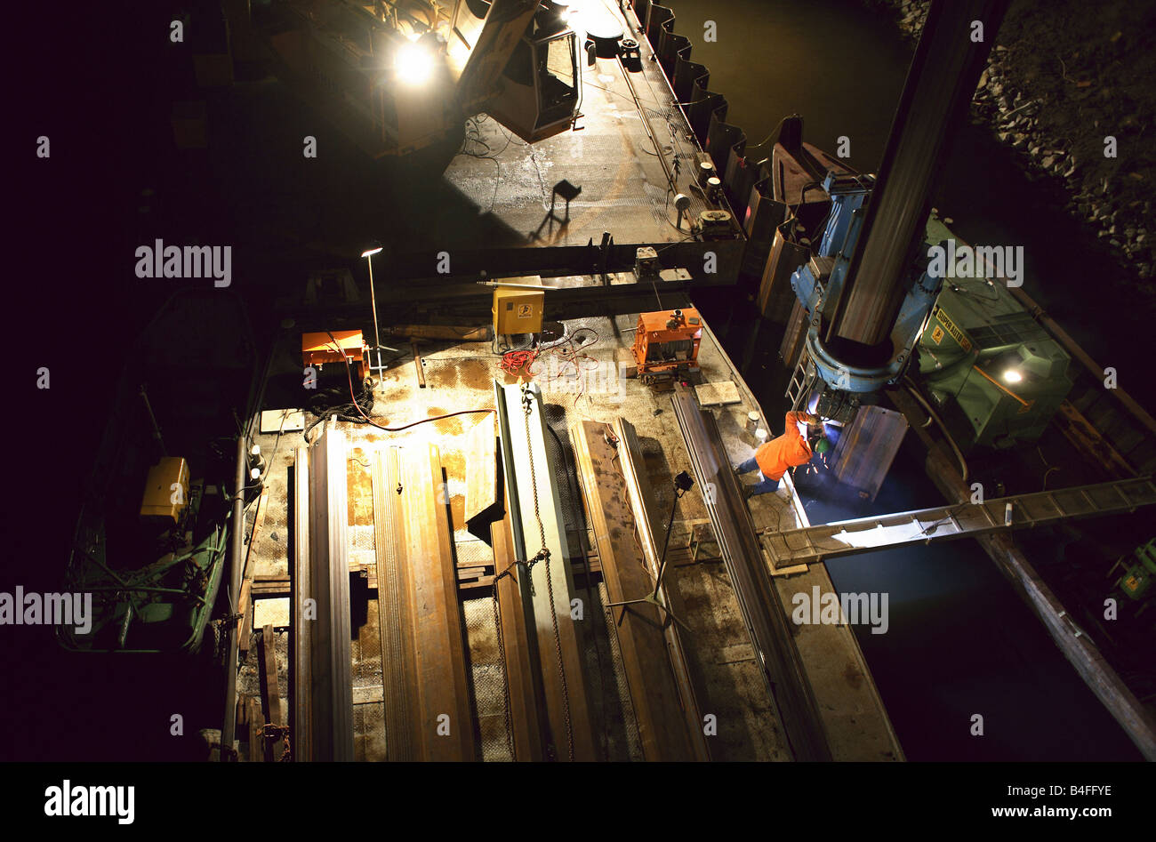 Man working on a ship during bank reinforcement of the Teltow Channel, Berlin, Germany Stock Photo