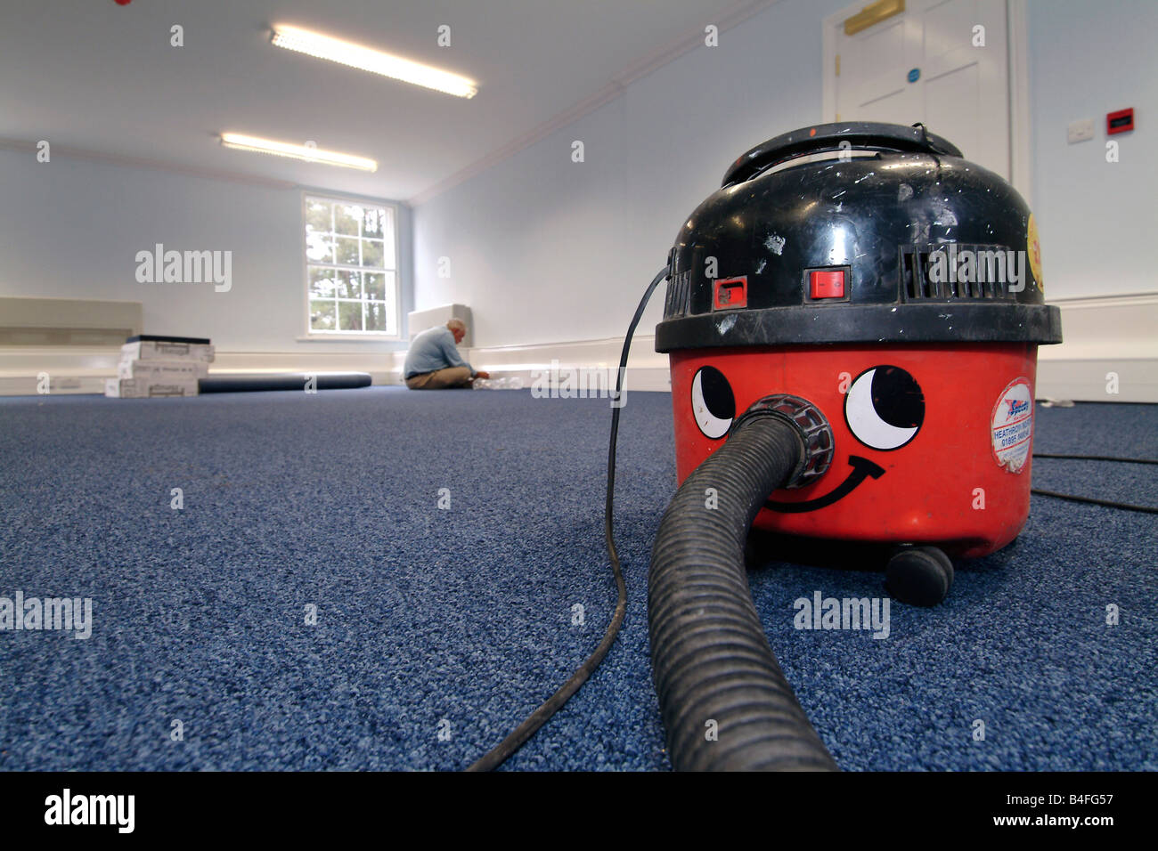 'Henry' vacuum cleaner waiting to be used by a carpet fitter in a newly refurbished office premises Stock Photo