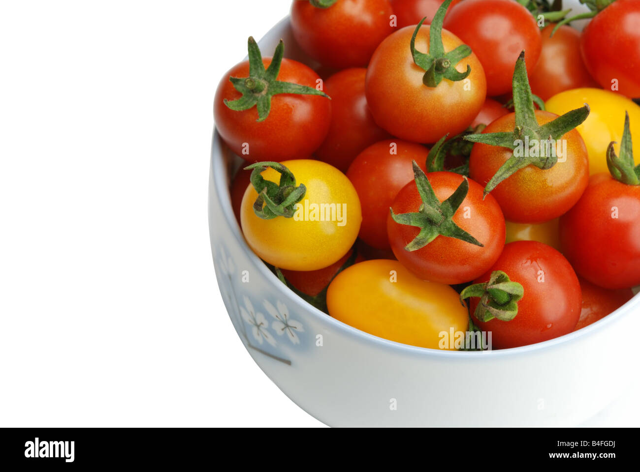 Red and yellow tomato fruits in a bowl Stock Photo - Alamy