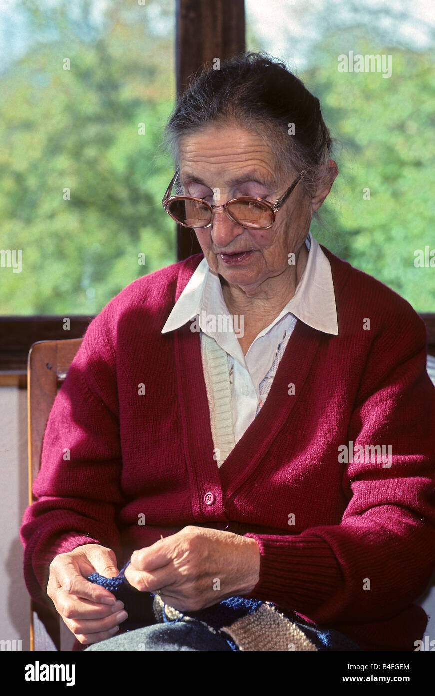 Grand mother knitting by the window Stock Photo - Alamy