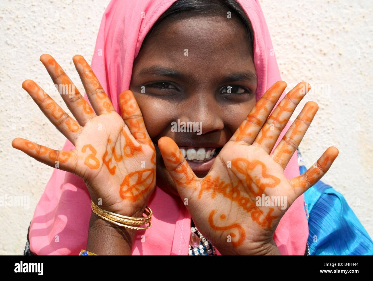 Moslem girl with Eid Mubarak henna on her hands , Eid ul Fitr celebrations , India Stock Photo