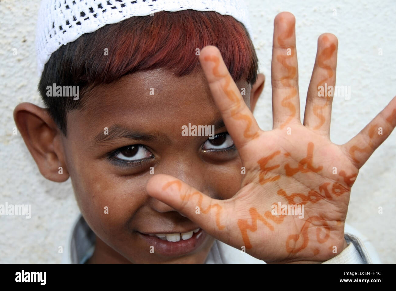 Moslem boy with Eid Mubarak henna on his hands , Eid ul Fitr celebrations , India Stock Photo