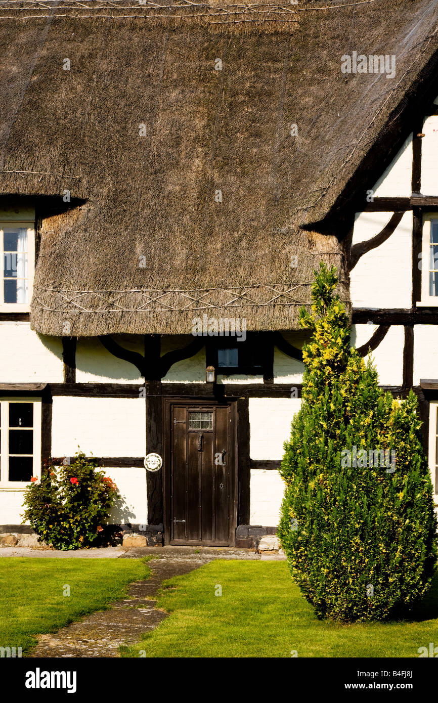 Close-up of the front of a typical English thatched country cottage in the village of All Cannings, Wiltshire, England, Great Br Stock Photo
