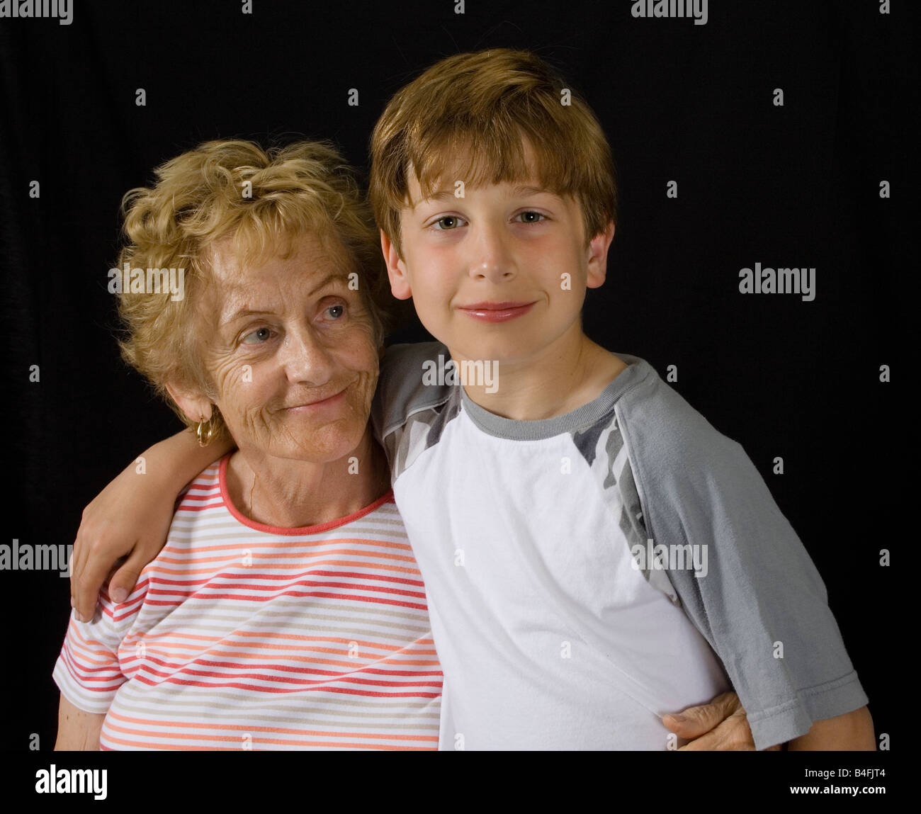 Color portrait of Grandmother and grandson. Holding each other in a loving way. Stock Photo