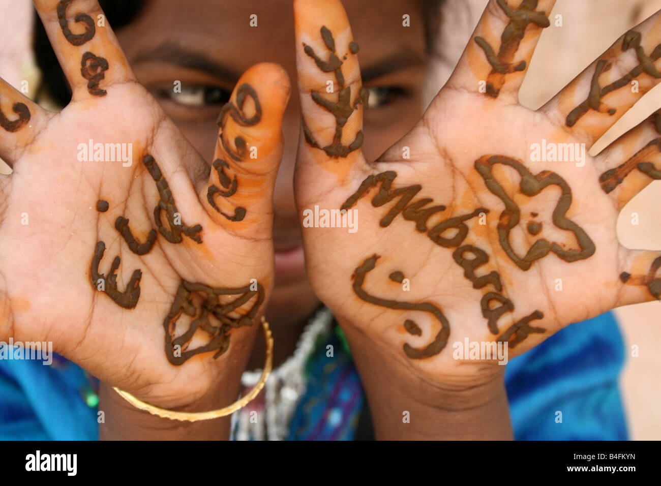 Moslem girl with Eid Mubarak henna paste on her hands , Eid ul Fitr celebrations , India Stock Photo