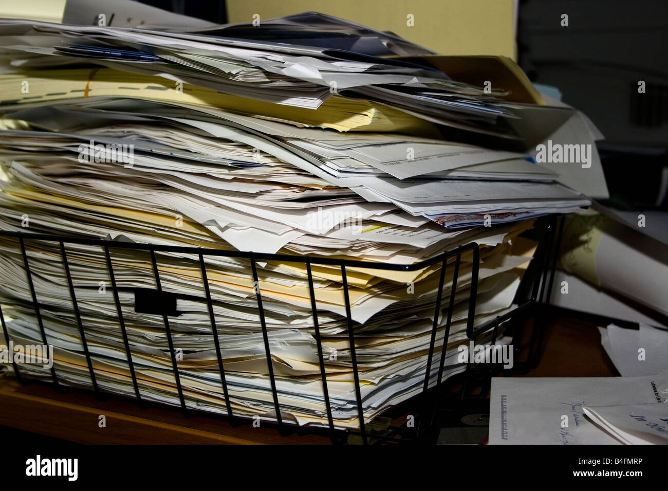 A pile of papers and file folders stacked to overflowing in a black