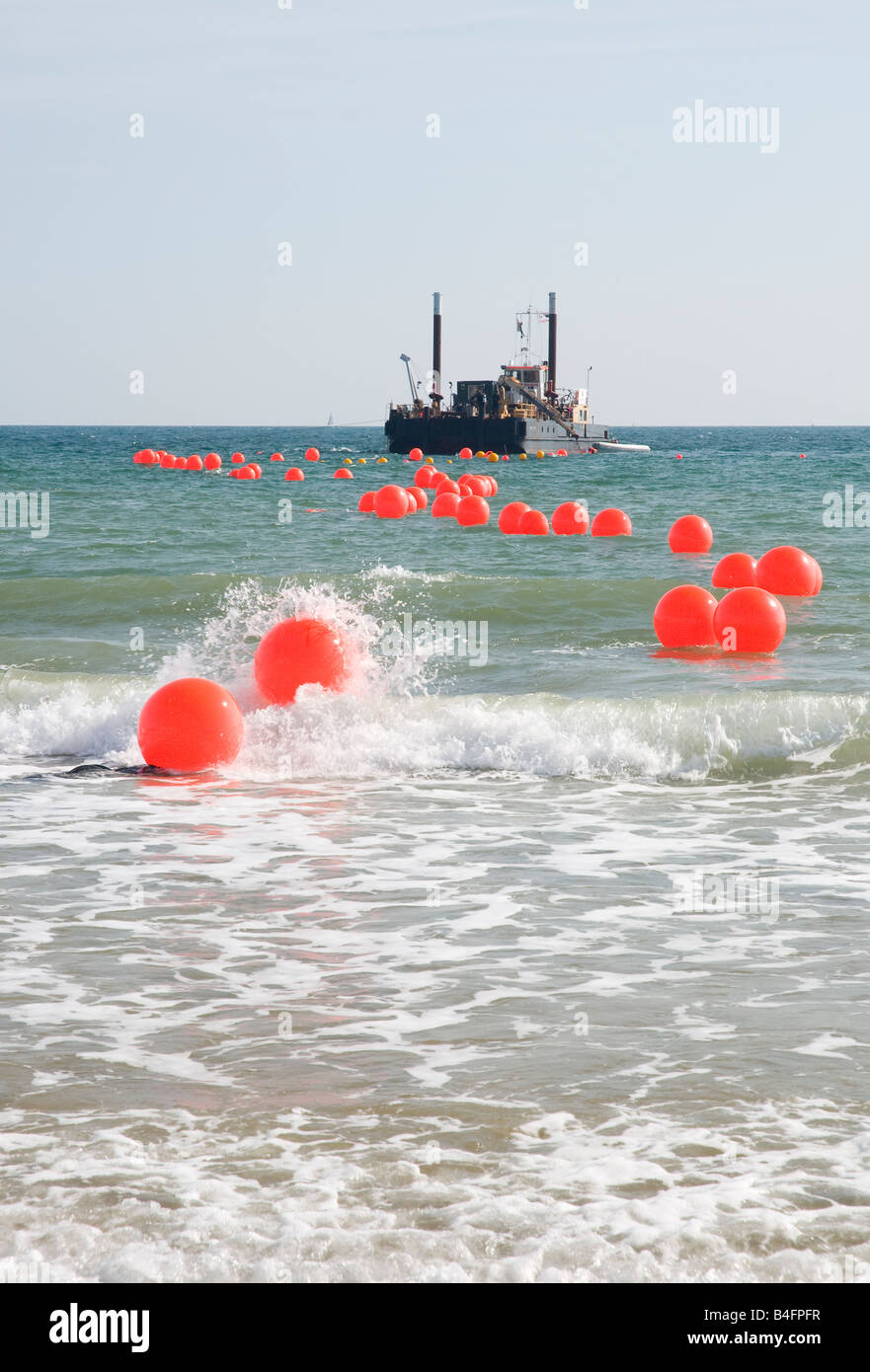 surf reef construction. Boat held in place to pump sand into