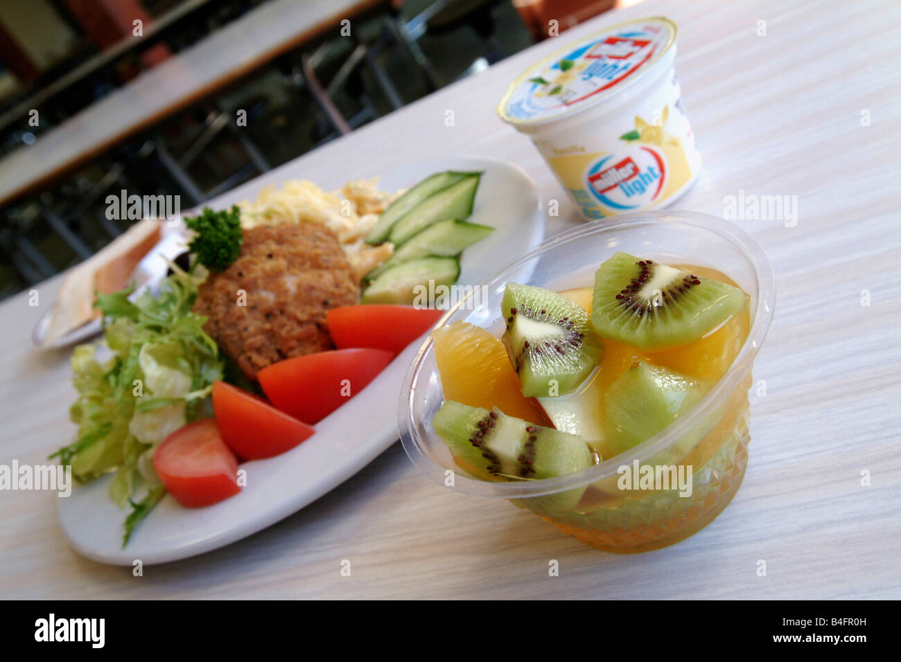 Plated light lunch with fruit and yoghurt in a canteen setting Stock