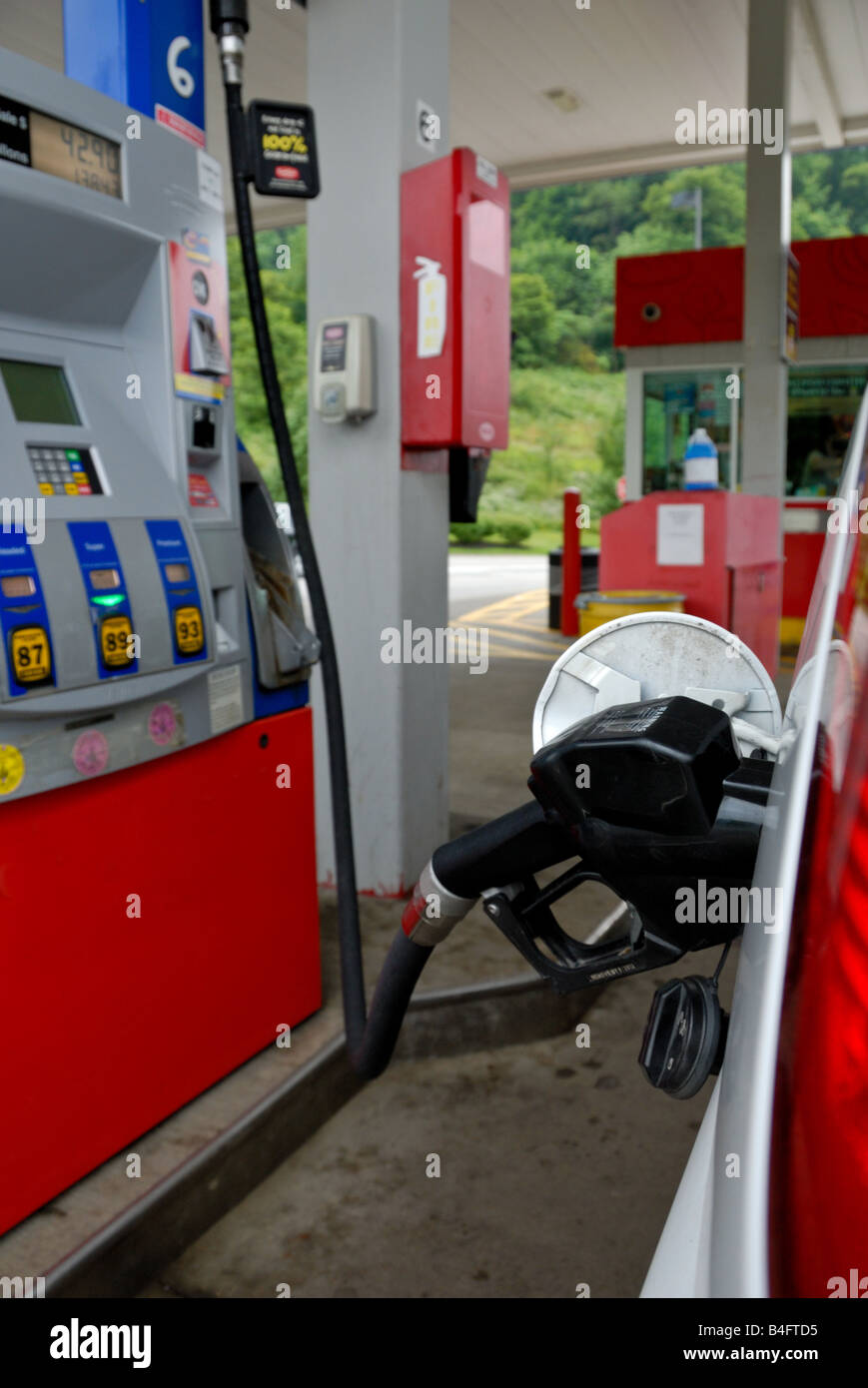 Hose from gasoline pump is shown refueling a Spots Utility Vehicle at a