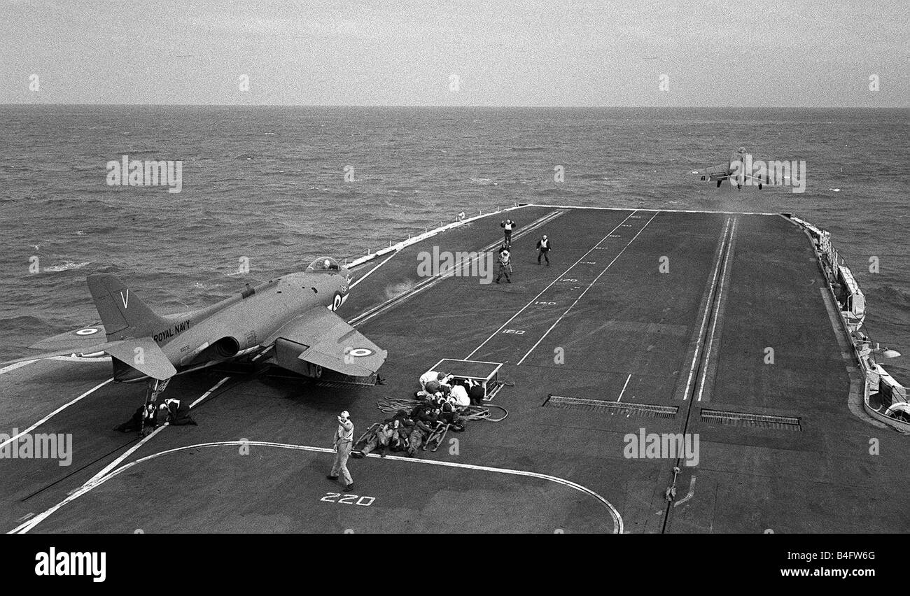 Fleet Air Arm Supermarine Scimitar aircraft 1959 waits to launch off the deck of Royal Navy Aircraft Carrier HMS Victorious as another aircraft take to the air using the steam catapult Stock Photo