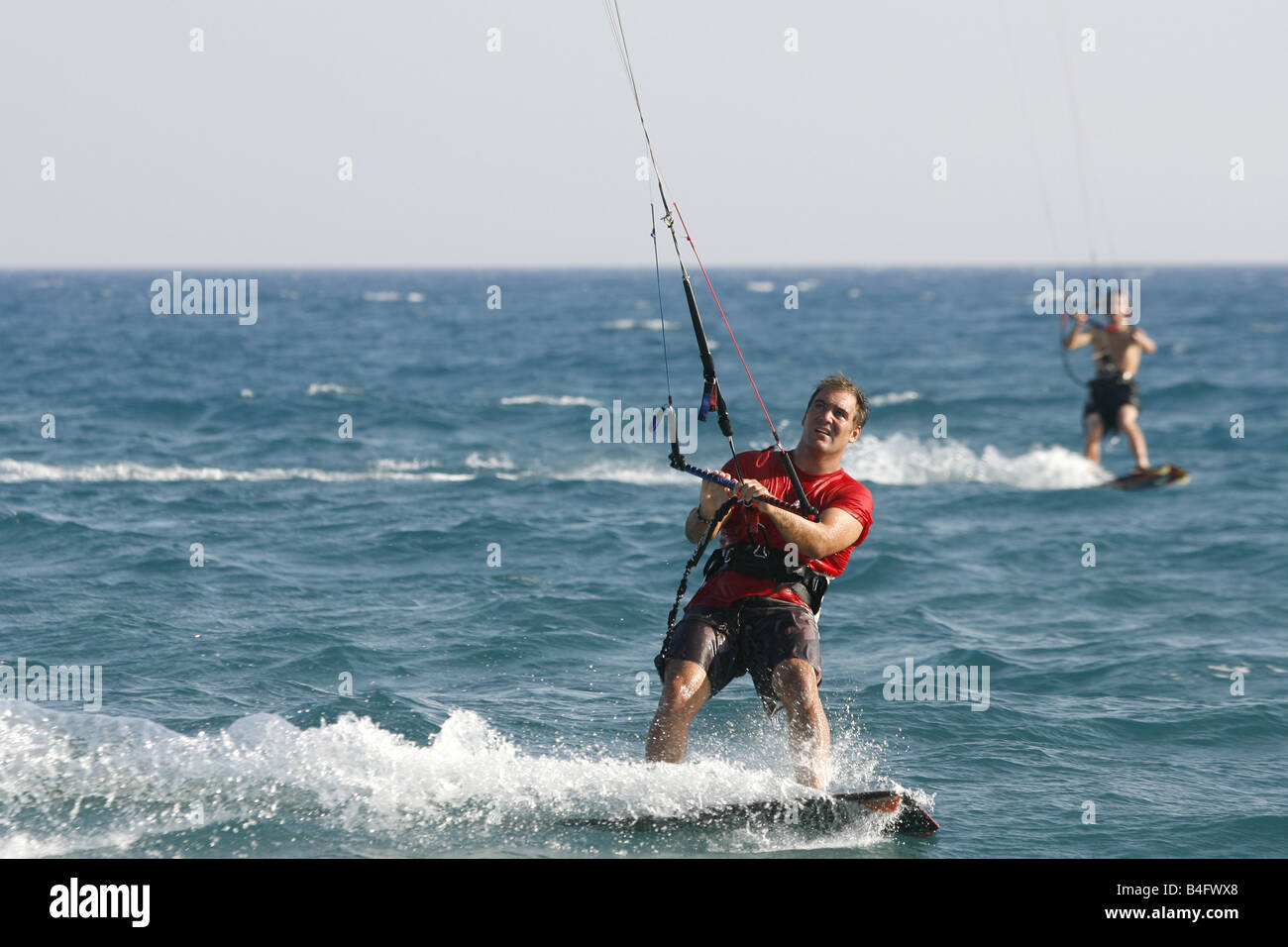 A Kite Surfing instructor demonstrates Kite Surfing in the sea off Paramali Beach near the seaside village of Pissouri in Cyprus Stock Photo