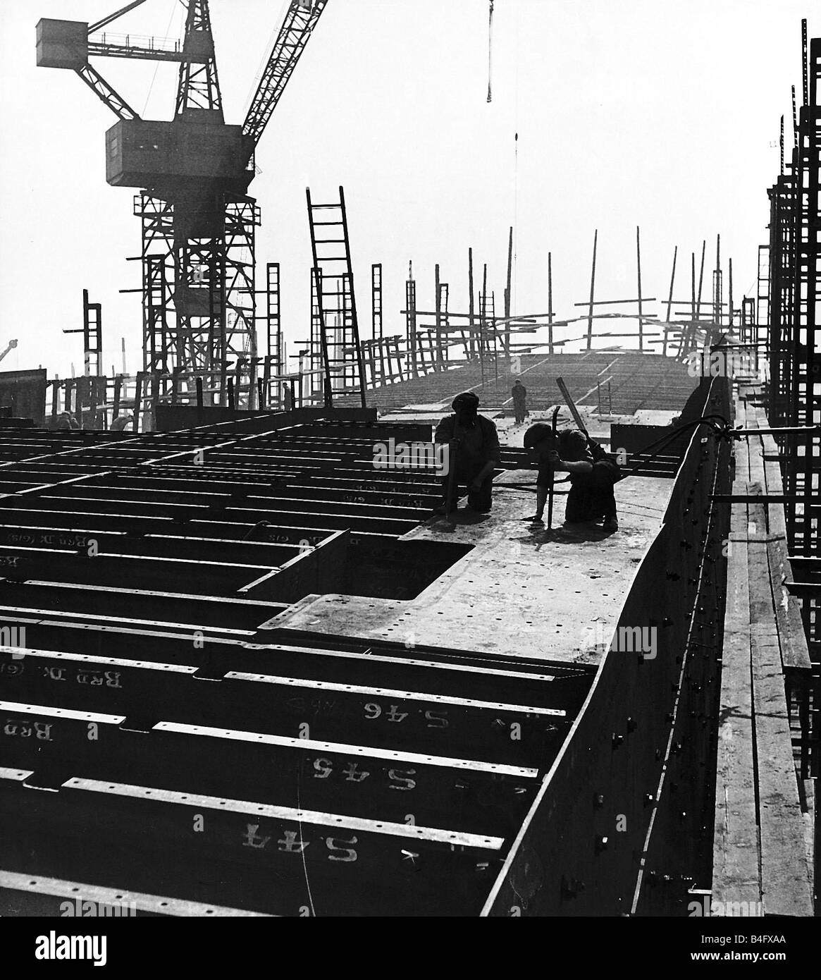 General view of Shipbuilders at work in a shipyard Circa 1955 Stock