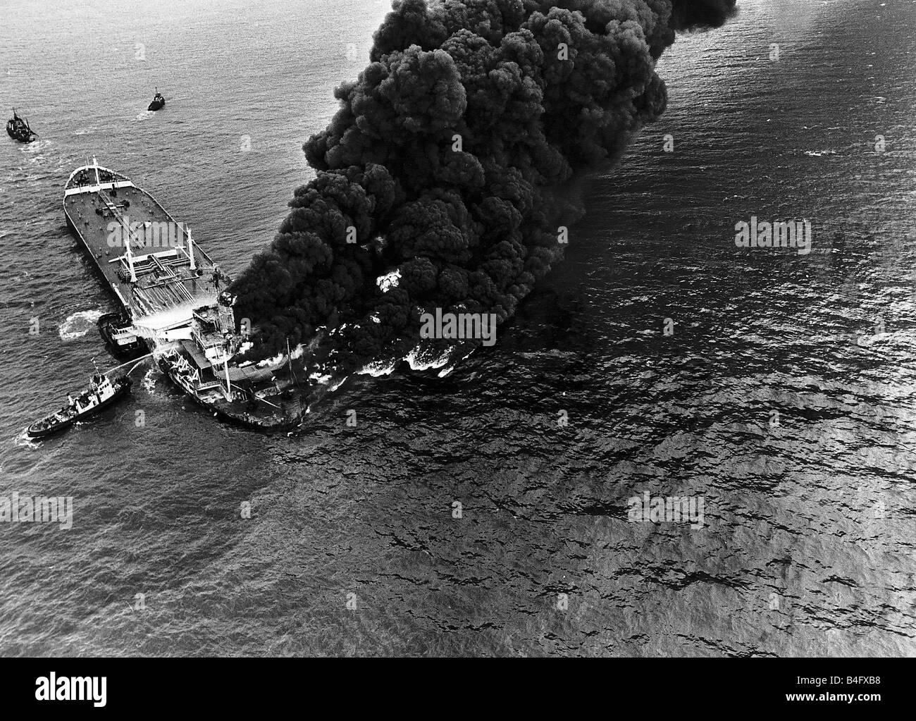 Plumes of smoke from oil tanker Pacific Glory as it is towed towards a beaching point after being hit by another tanker the Allegro October 1970 Stock Photo