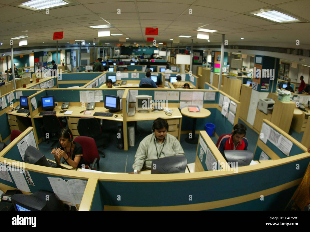 Workers in their own cubicles at an Indian Call centre in New Delhi India July 2002 Stock Photo