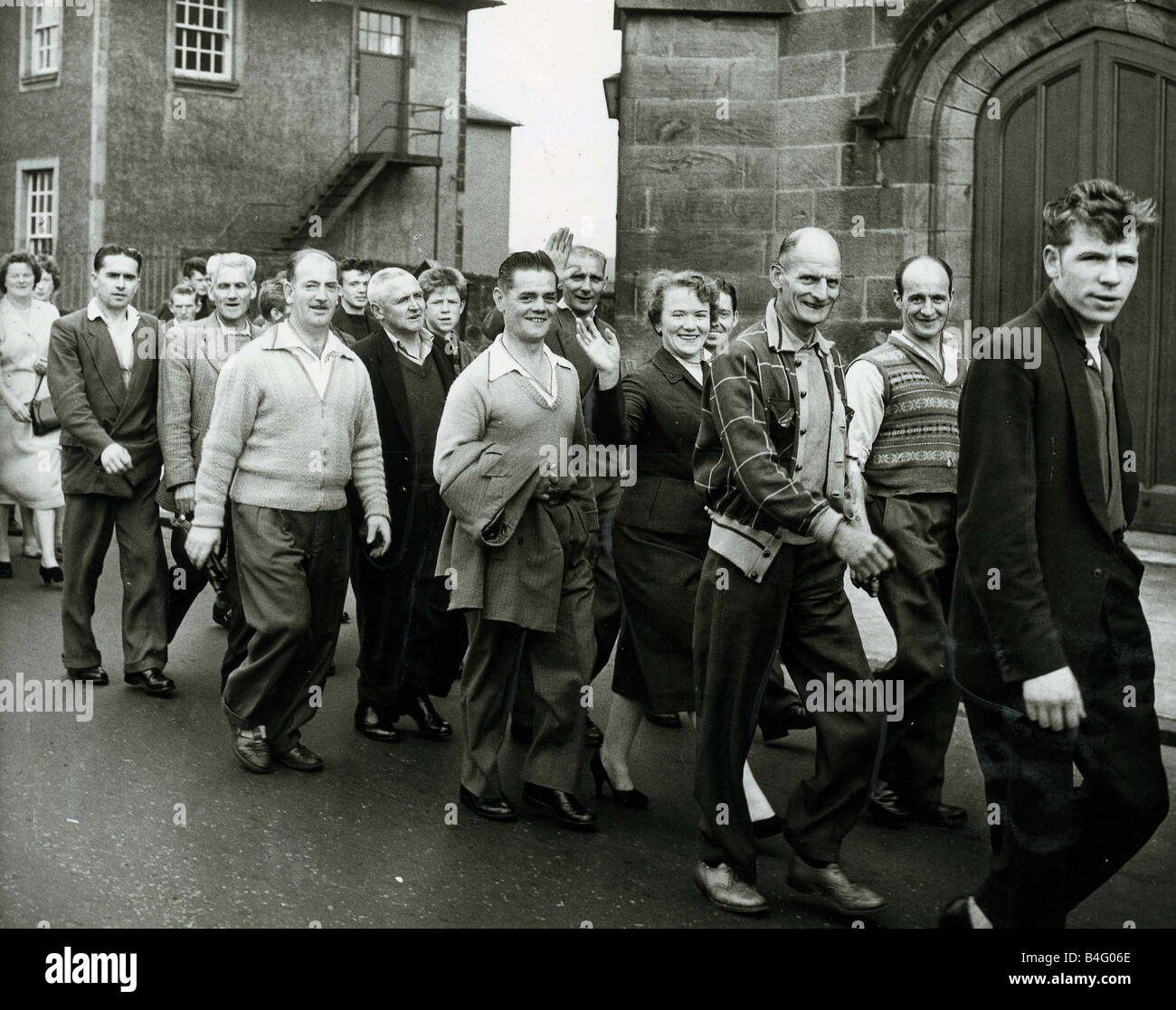 Striking coal miners walk through streets during the pit strike in Alloa Scotland June 1959 Stock Photo
