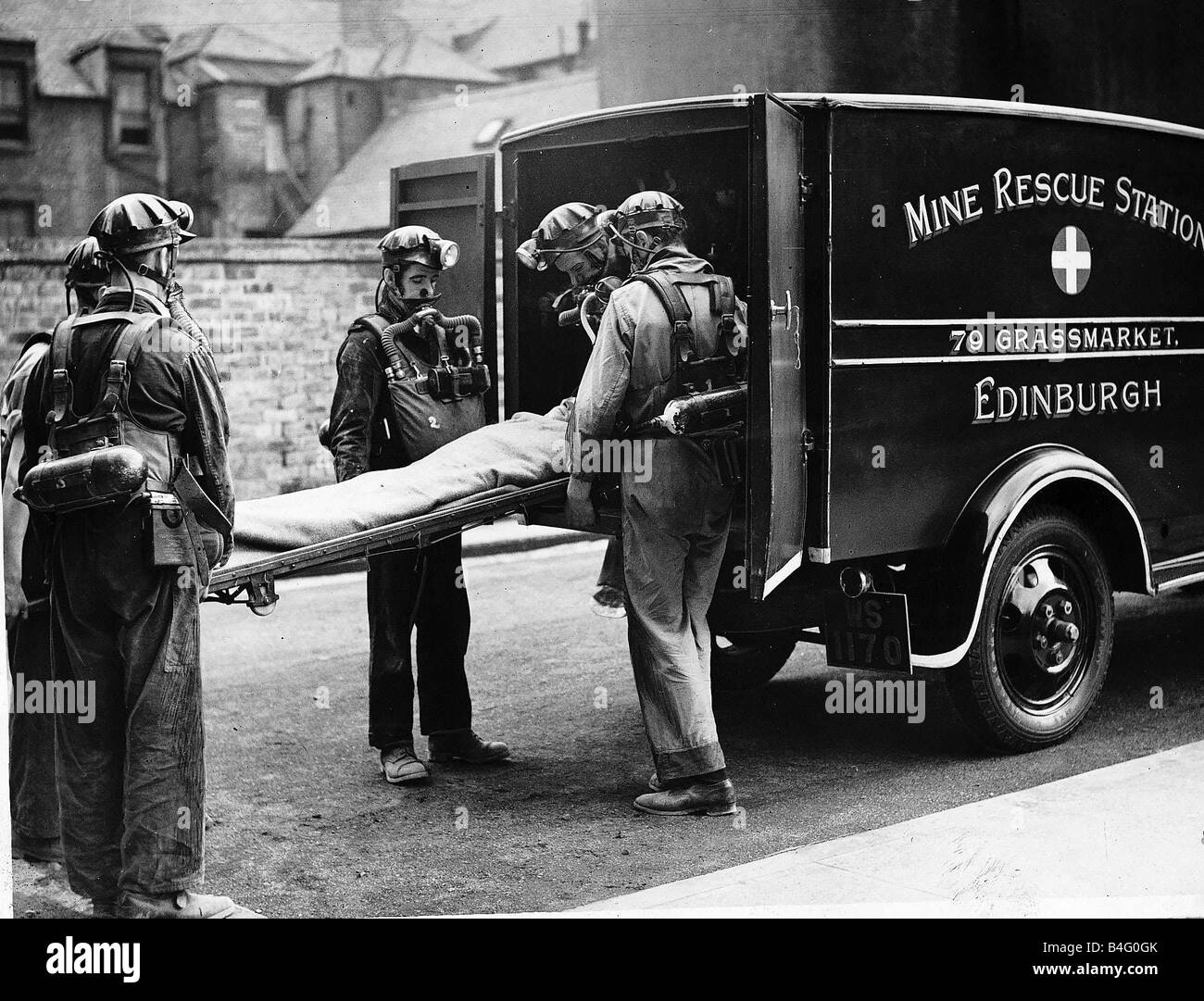 Mine Rescue Service team carry an injured miner onto their ambulance in Edinburgh Scotland Circa 1940 Stock Photo