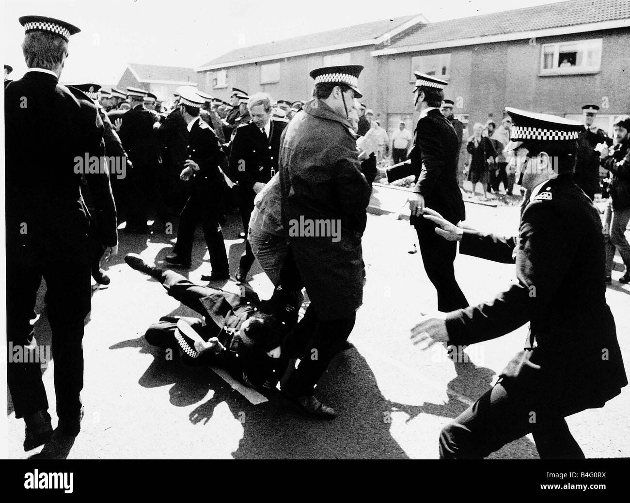 Police attend to an injured protester on the picket line at Ravenscraig in Scotland during the Miners strike May 1984 Stock Photo
