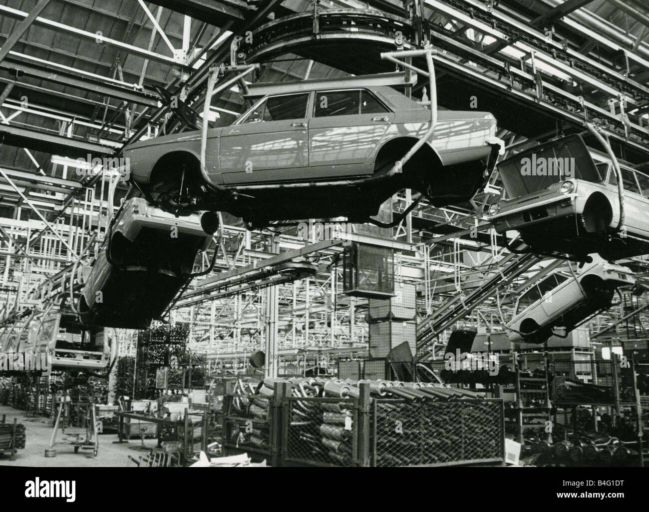 Factory production line with Hillman Imp and Hillman Hunter models hanging from cradles at Rootes factory Linwood March 1969 Stock Photo