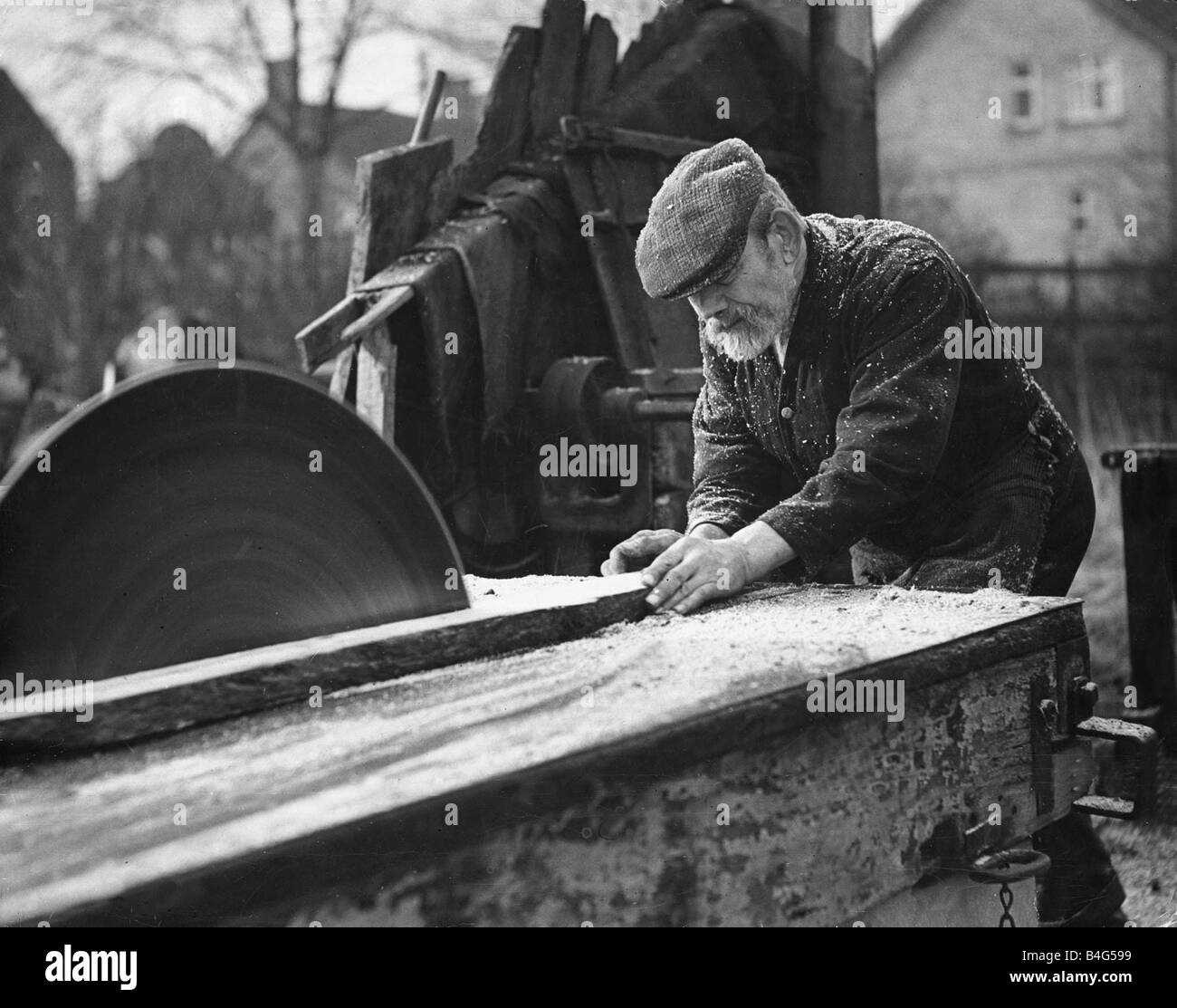 Wheelwright William Punday aged 73 seen here working with a circular saw February 1935 Stock
