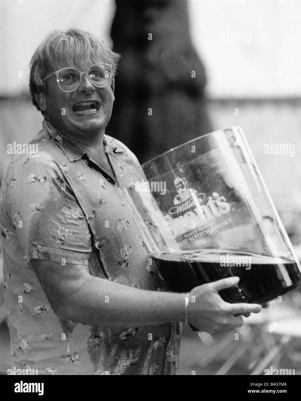 Christopher Biggins with giant glass of Grants Whisky 1989 Stock Photo -  Alamy