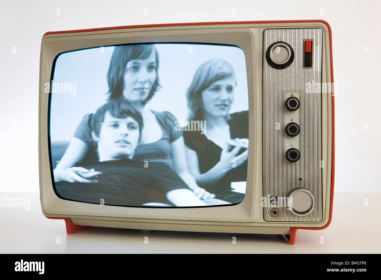 A television with a black and white image of three young people Stock Photo