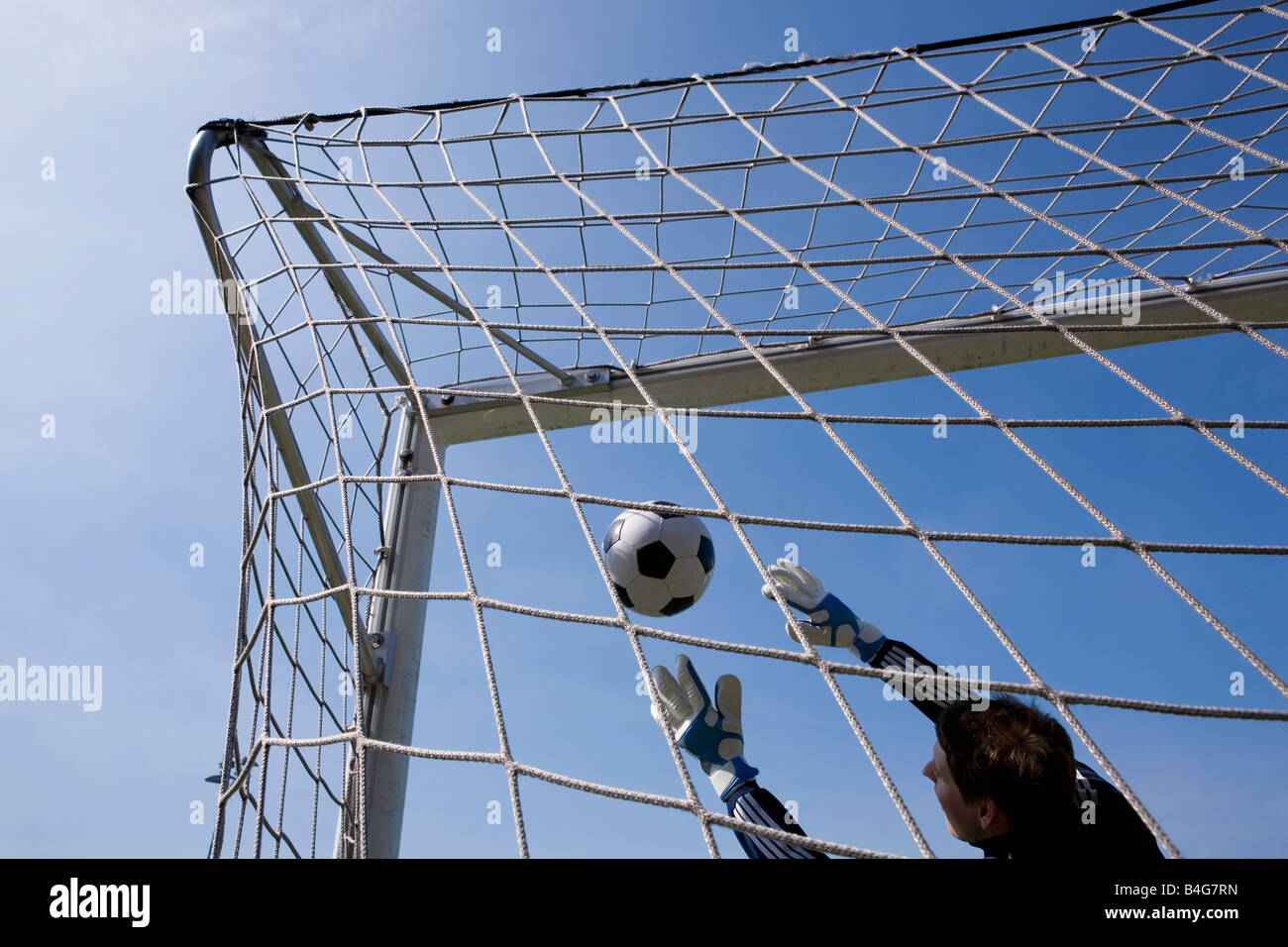 A goalie reaching to catch a soccer ball Stock Photo Alamy