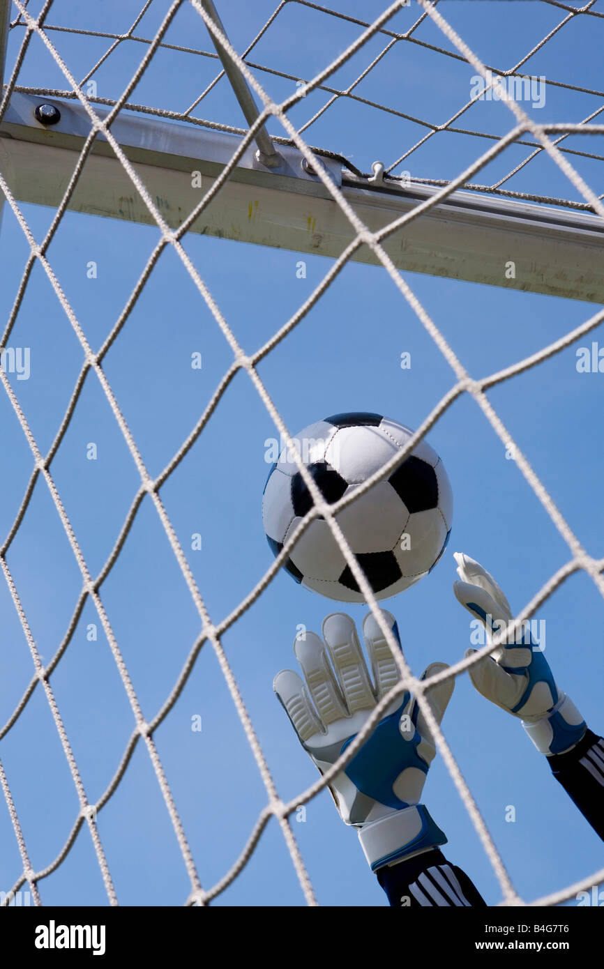 Goalies hands reaching soccer ball hires stock photography and images