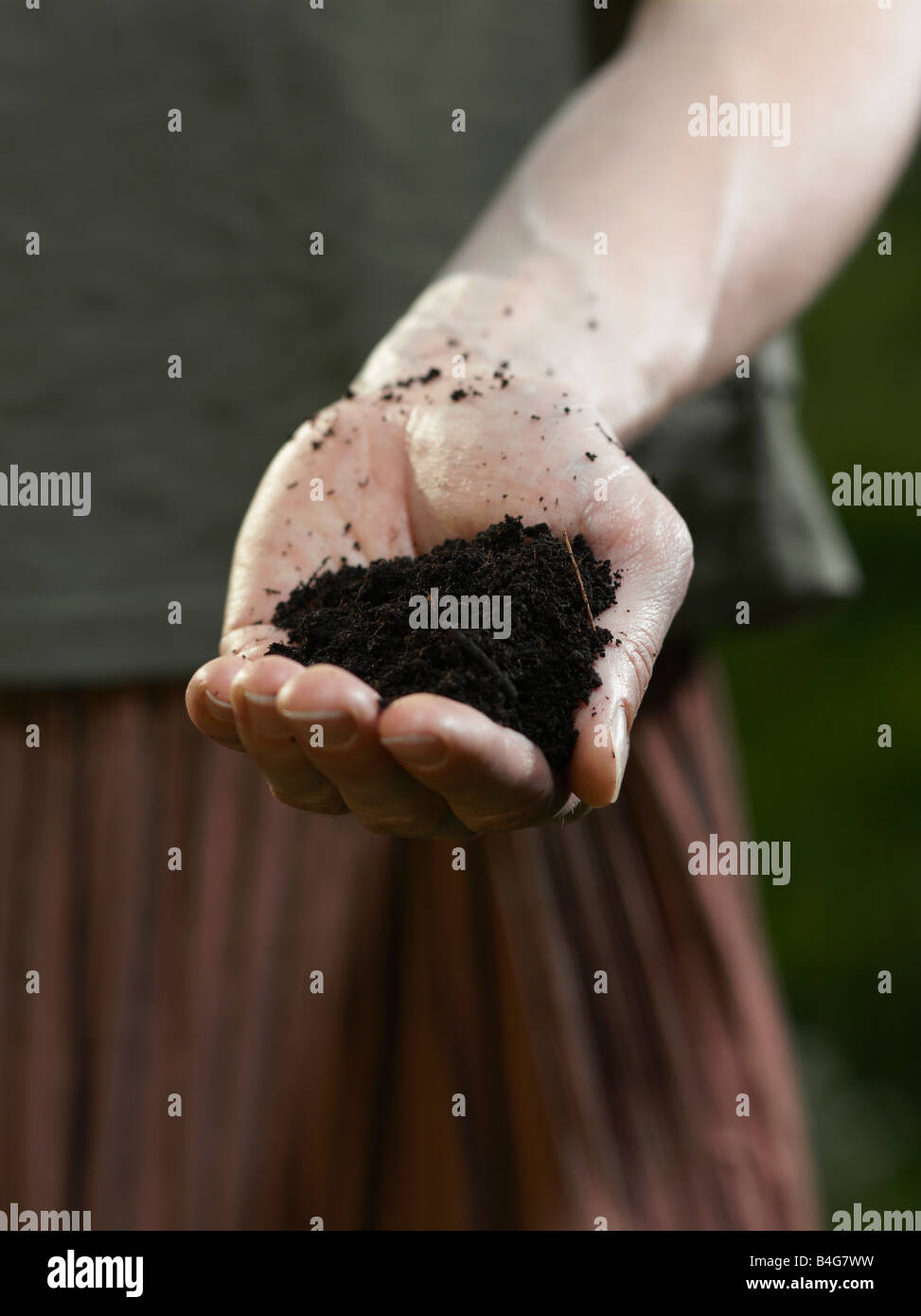 A human hand holding a pile of dirt Stock Photo Alamy