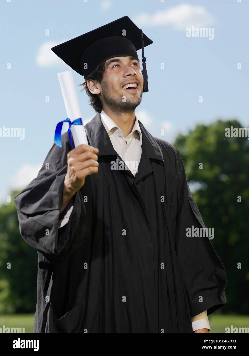 A male graduate holding a diploma Stock Photo - Alamy
