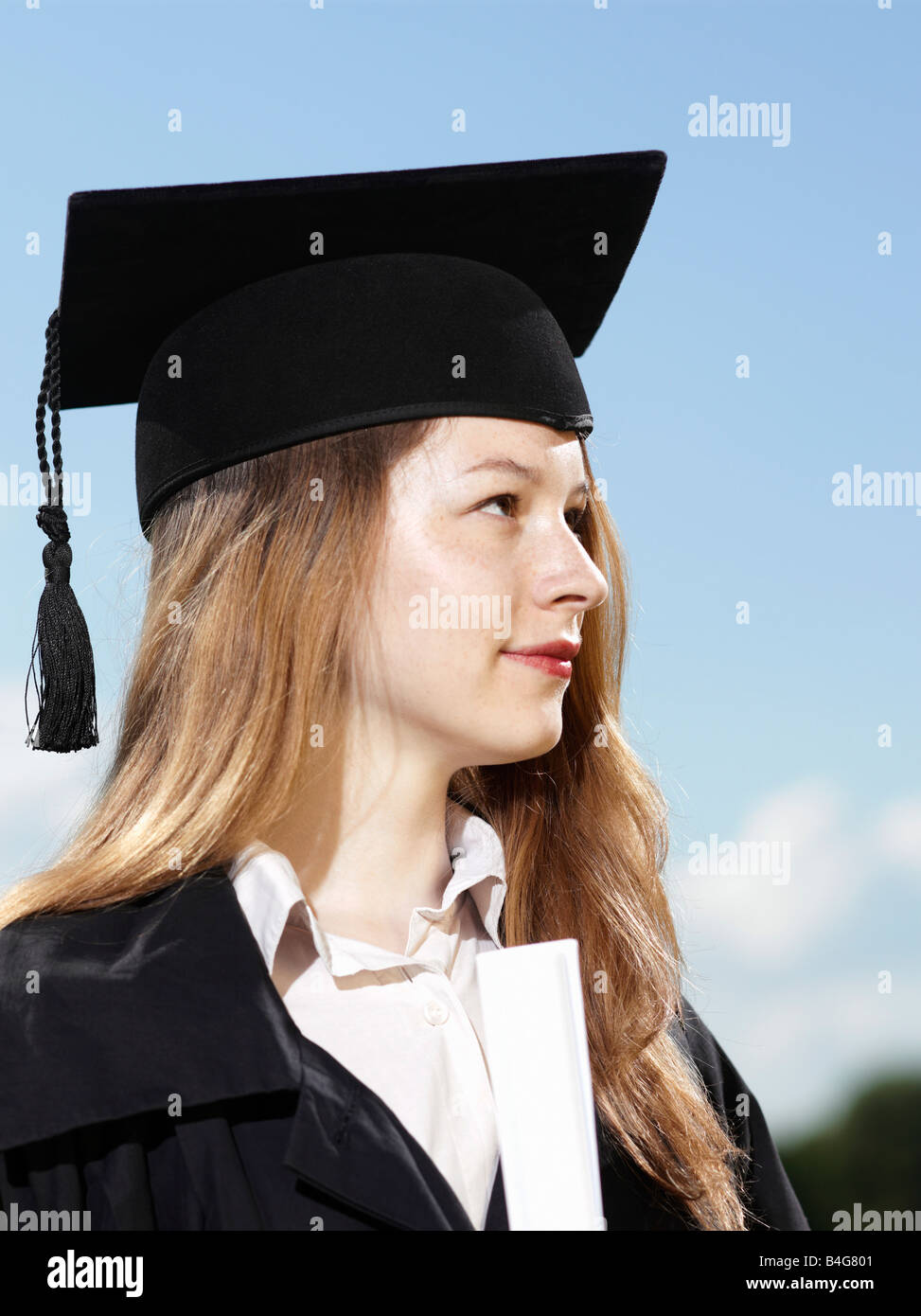 A female graduate holding a diploma Stock Photo - Alamy