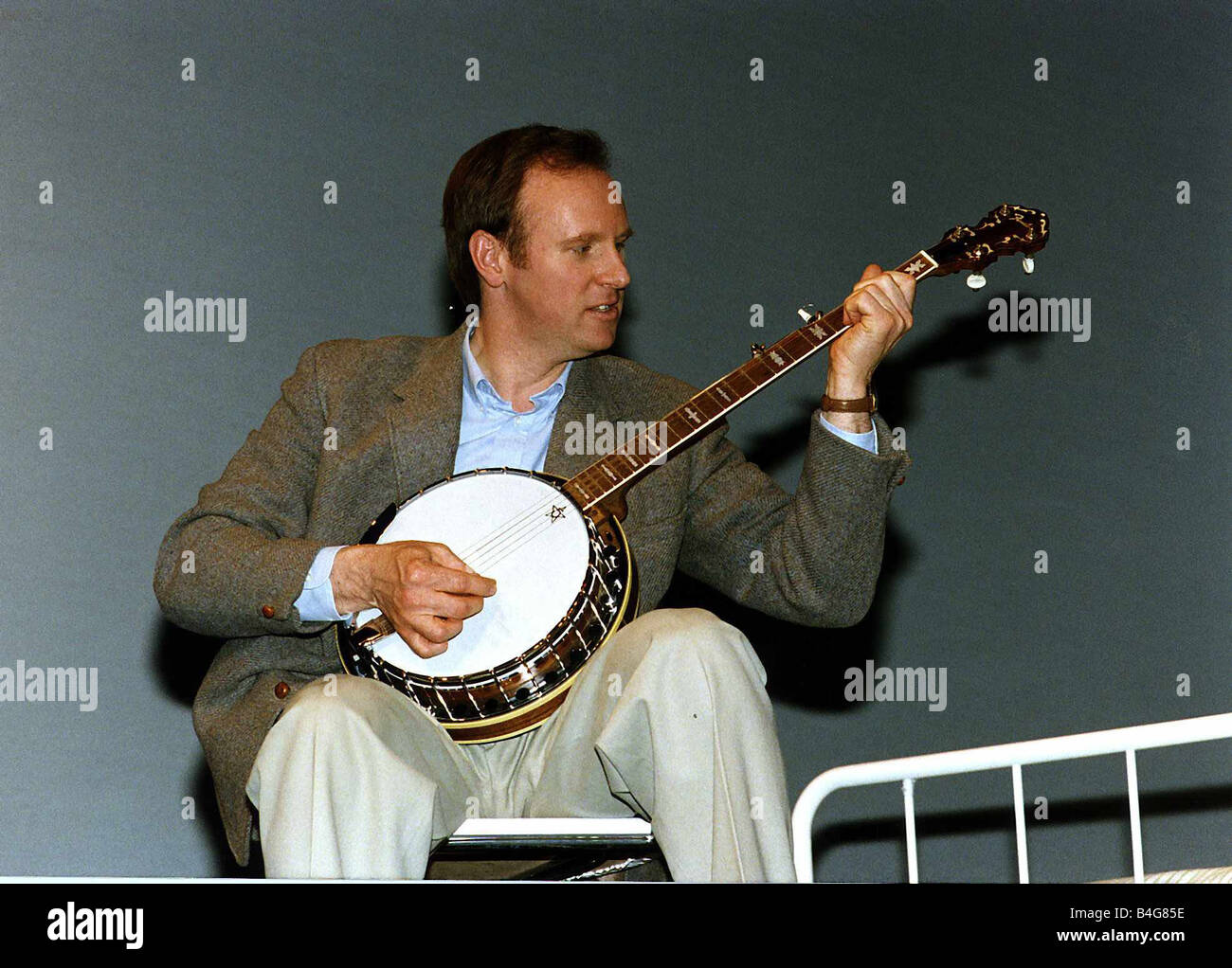 Peter Davison Actor playing a banjo Stock Photo - Alamy