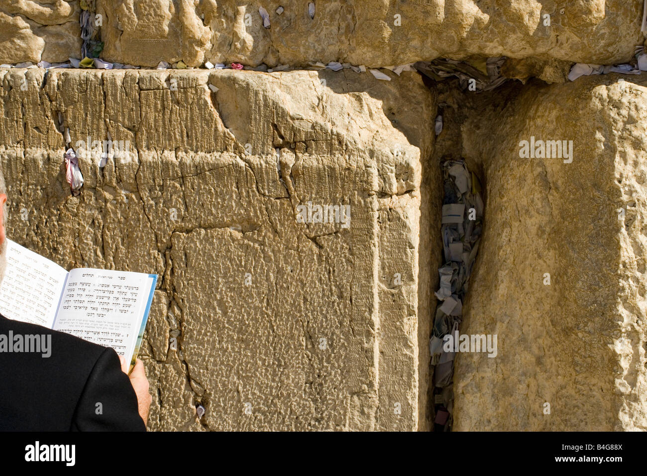 Man praying at the Wailing Wall, over the shoulder view, close-up Stock Photo