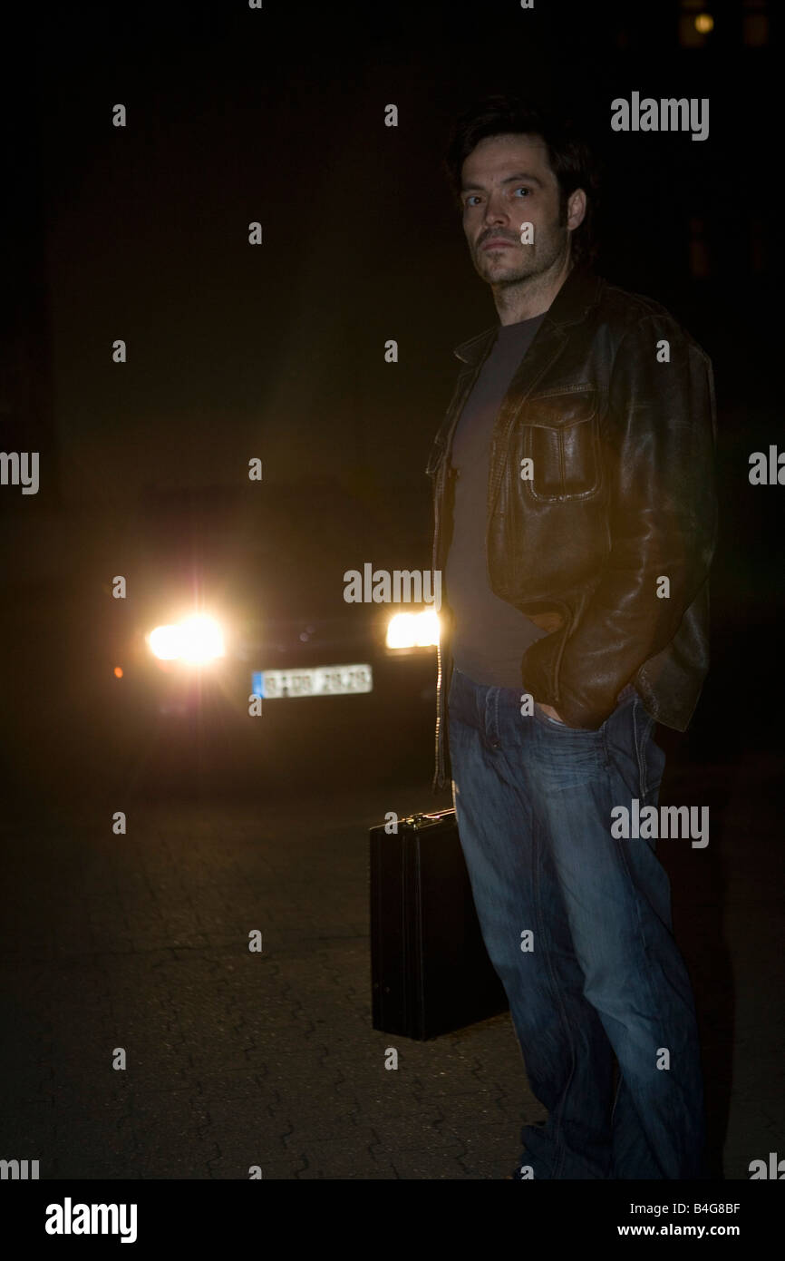 Man standing in front headlights hires stock photography and images