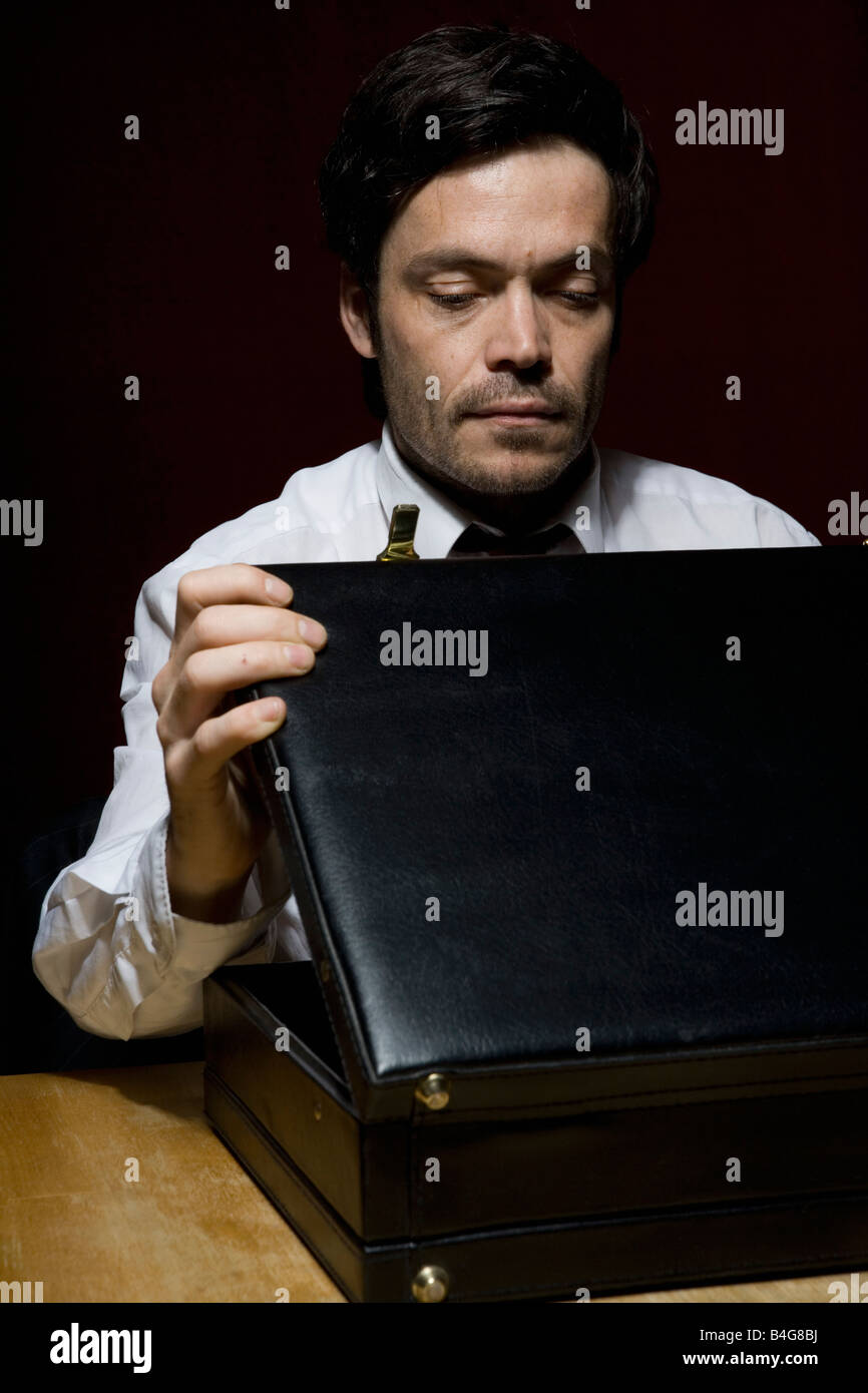 A man looking into a briefcase Stock Photo Alamy