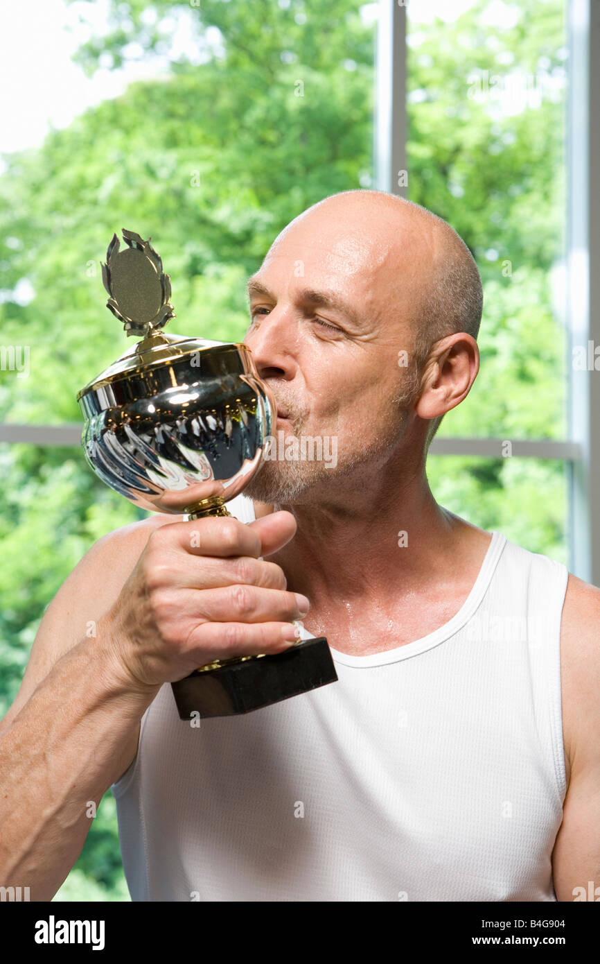 A man kissing a trophy Stock Photo