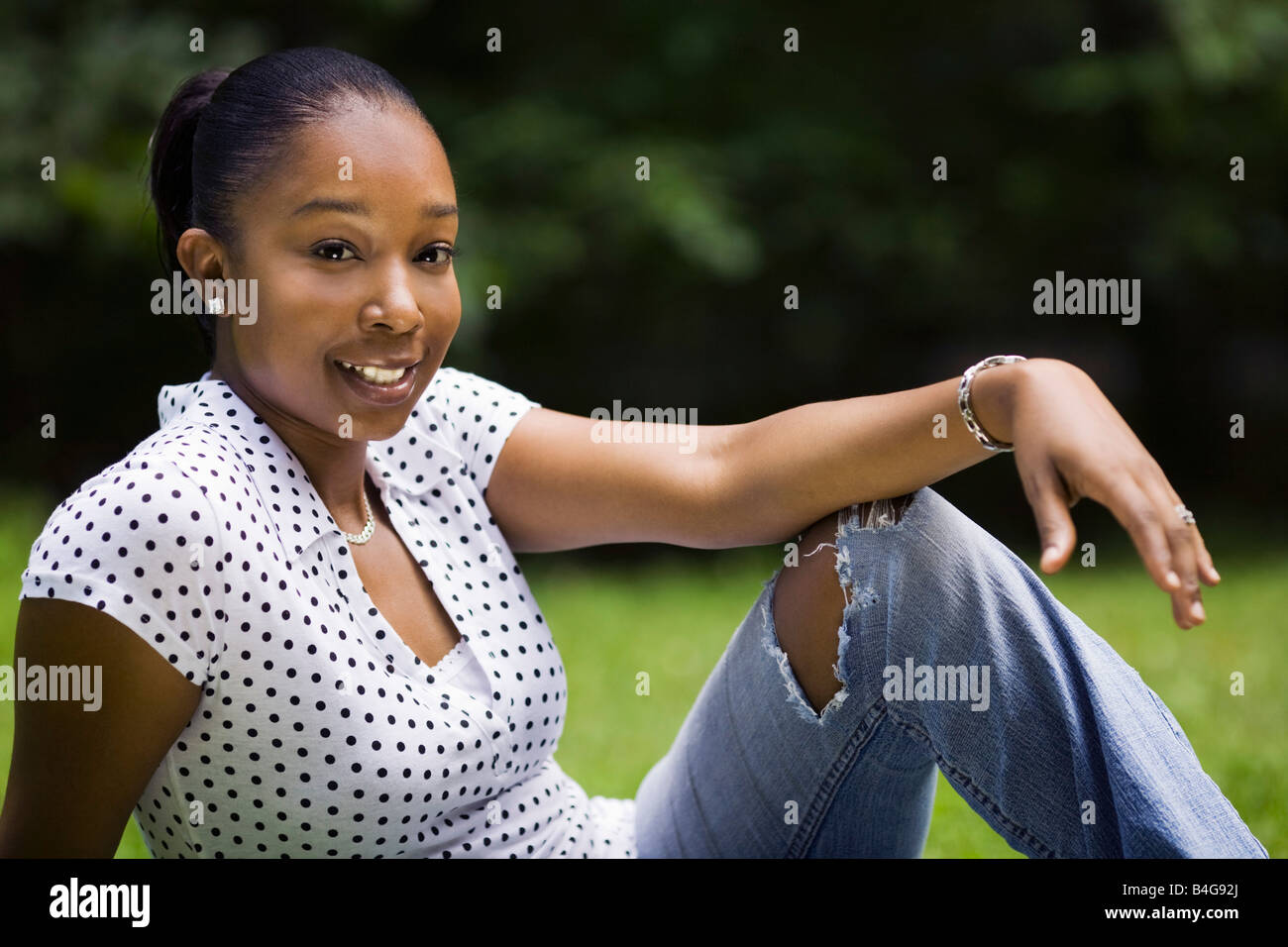 A young woman relaxing in a yard Stock Photo