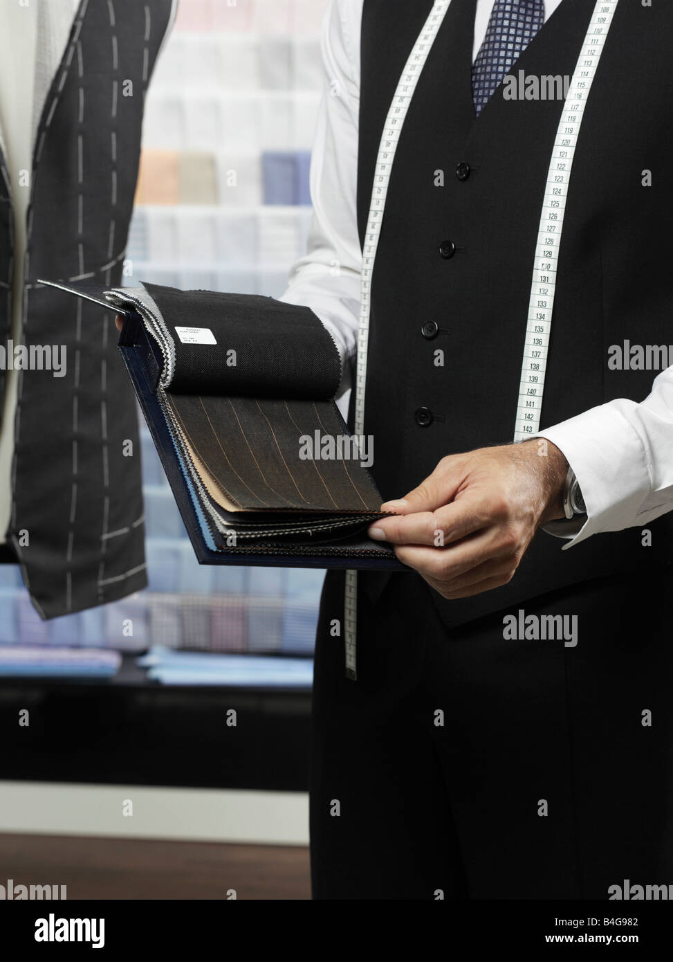 A tailor with samples of fabric Stock Photo - Alamy