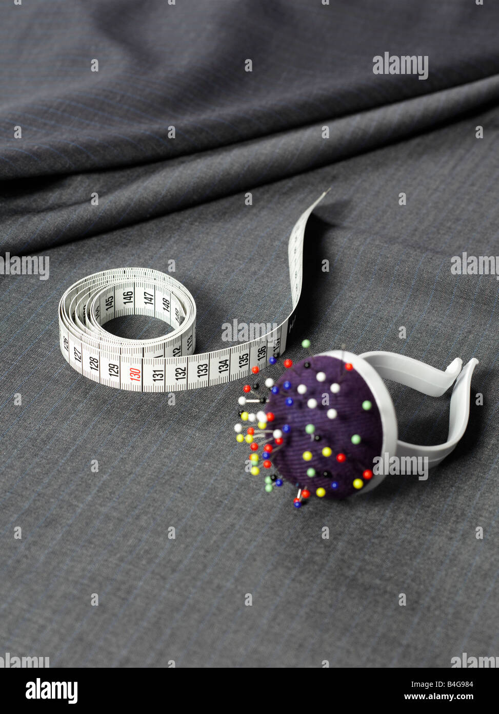 A tape measure, pin cushion and fabric Stock Photo Alamy