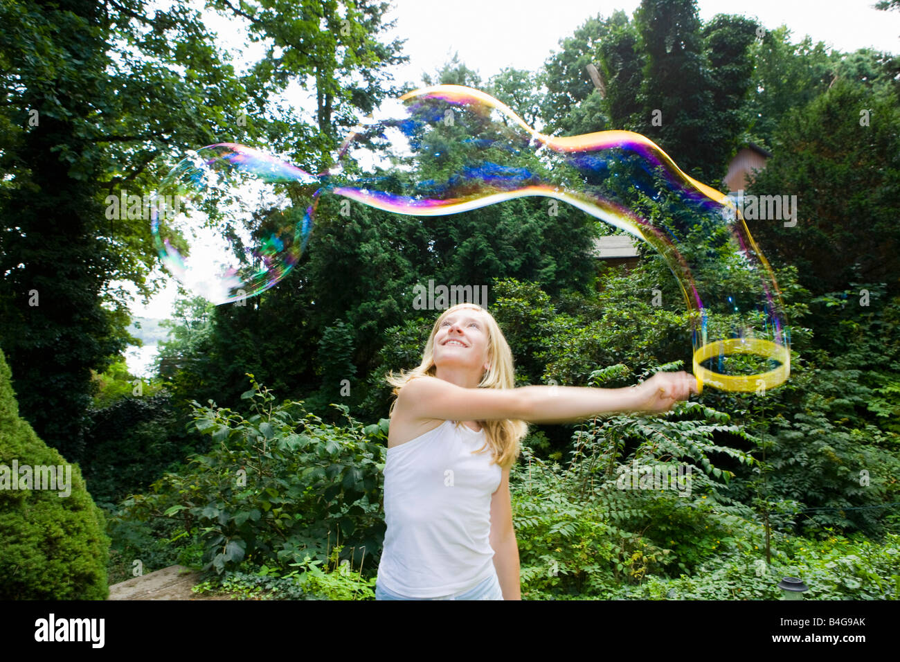 A Girl Making Bubbles With A Bubble Wand Stock Photo Alamy a-girl-making-bubbles-with-a-bubble-wand-stock-photo-alamy