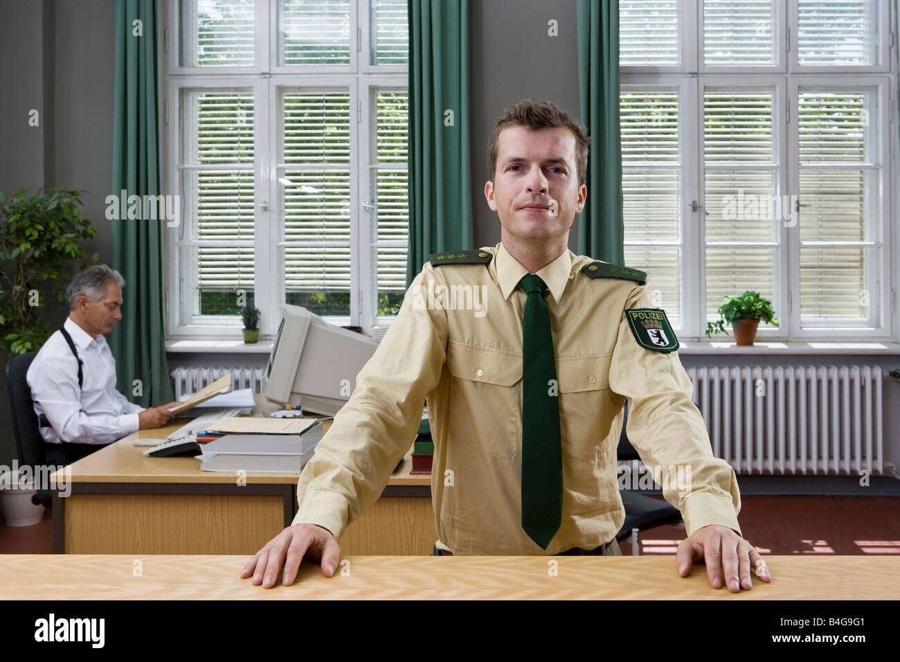 Two police officers working in an office Stock Photo Alamy