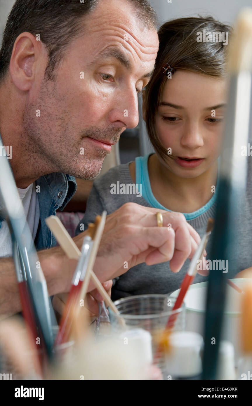 A father helps his daughter at a pottery studio Stock Photo - Alamy