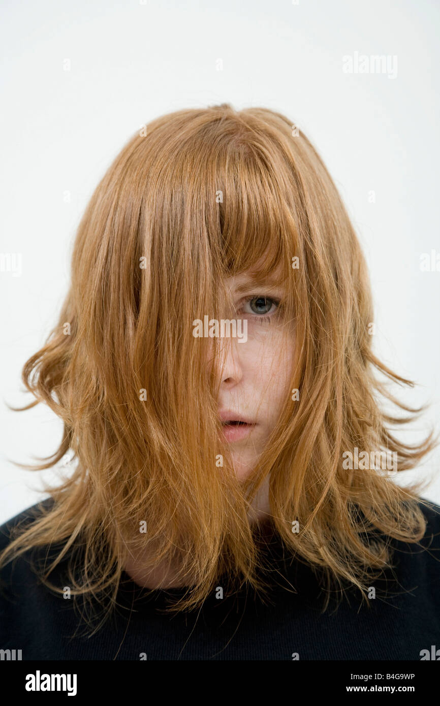A woman with tousled hair hanging in her face Stock Photo